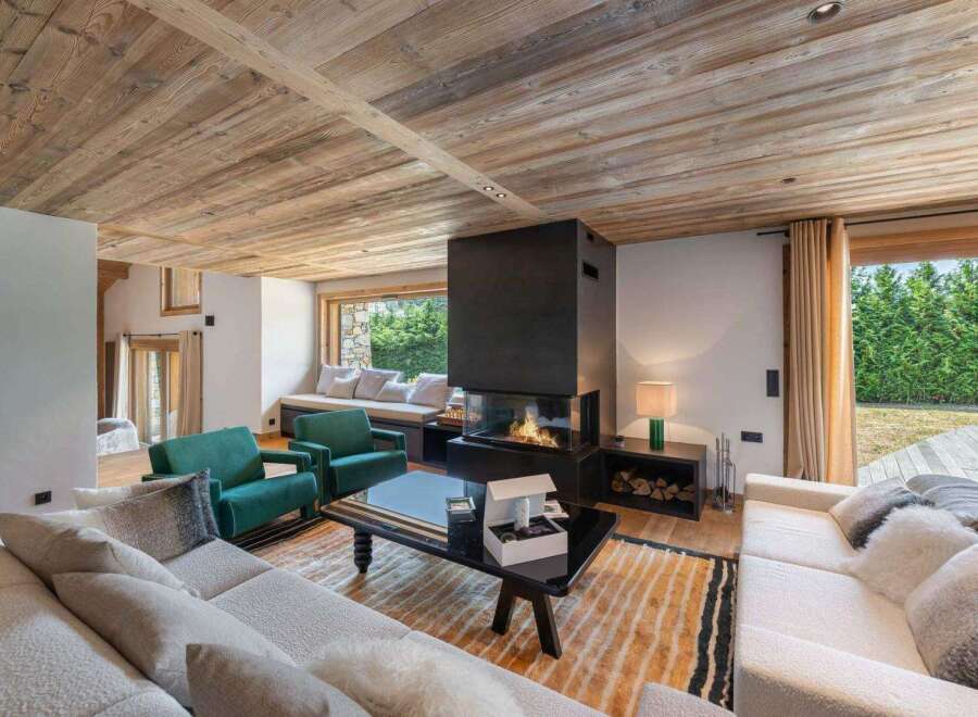 Experience luxury living in this stunning property featuring a cozy living room with a modern fireplace and comfortable seating.