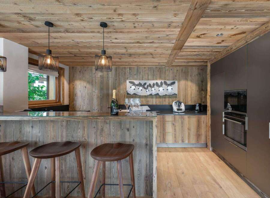 Experience rustic elegance in this stunning kitchen! Featuring a beautiful wooden ceiling and walls, this space exudes warmth and charm.