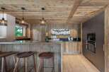 Experience rustic elegance in this stunning kitchen! Featuring a beautiful wooden ceiling and walls, this space exudes warmth and charm.