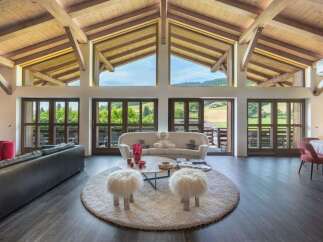 Experience luxury living in this stunning property, featuring a spacious living room with breathtaking views.