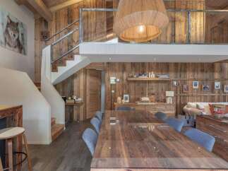 This stunning property boasts a rustic charm with its wooden walls and ceiling, creating a warm and inviting atmosphere.