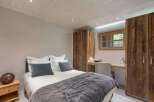 Discover the charm of this cozy bedroom, featuring a comfortable bed and stylish decor.
