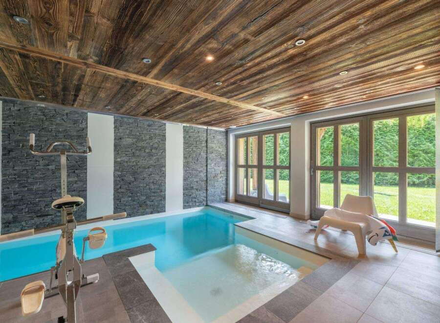 This luxurious indoor pool offers a serene retreat with its sleek design and inviting ambiance.