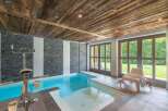 This luxurious indoor pool offers a serene retreat with its sleek design and inviting ambiance.
