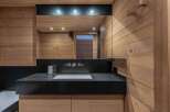 This luxurious bathroom features a sleek black countertop with a modern sink and faucet.