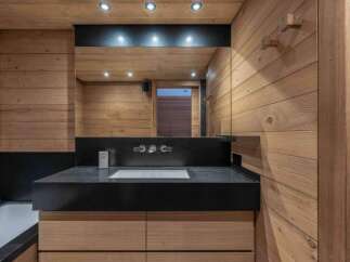 This luxurious bathroom features a sleek black countertop with a modern sink and faucet.