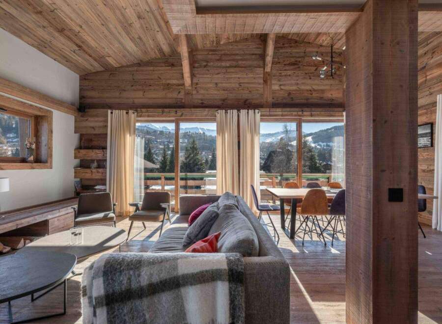 Experience luxury living in this stunning property, featuring a beautifully designed interior with exposed wooden beams and a cozy fireplace.
