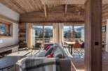 Experience luxury living in this stunning property, featuring a beautifully designed interior with exposed wooden beams and a cozy fireplace.