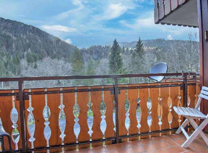 Enjoy breathtaking mountain views from this charming balcony.