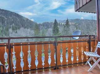 Enjoy breathtaking mountain views from this charming balcony.
