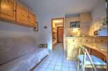 Discover this cozy apartment featuring a well-equipped kitchen, perfect for preparing meals.