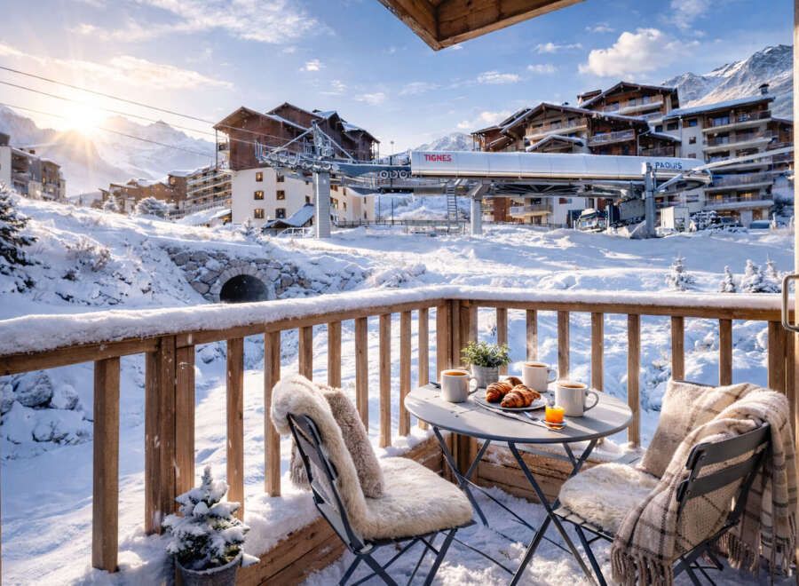 Enjoy breathtaking mountain views from this cozy ski chalet balcony.