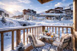 Enjoy breathtaking mountain views from this cozy ski chalet balcony.