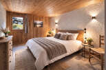 Experience rustic charm in this cozy bedroom! Featuring a wooden ceiling and walls, this space exudes warmth and comfort.