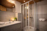 Step into a beautifully designed bathroom featuring a modern shower enclosure and a stylish vanity.
