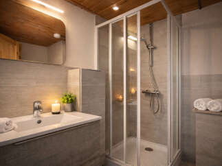 Step into a beautifully designed bathroom featuring a modern shower enclosure and a stylish vanity.