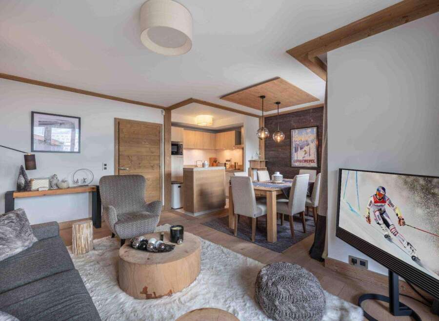 Experience luxury living in this stunning property, featuring a cozy living area with a plush rug and a unique wooden coffee table.