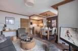Experience luxury living in this stunning property, featuring a cozy living area with a plush rug and a unique wooden coffee table.