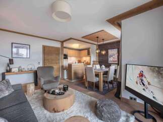 Experience luxury living in this stunning property, featuring a cozy living area with a plush rug and a unique wooden coffee table.