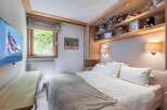 This cozy bedroom features a comfortable bed with plush pillows and a soft blanket, perfect for a relaxing retreat.