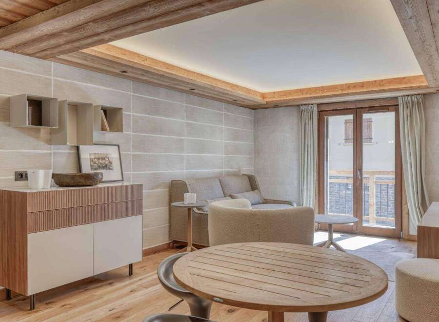 Experience luxury living in this stunning property, featuring a beautifully designed living room with wooden accents and a cozy atmosphere.