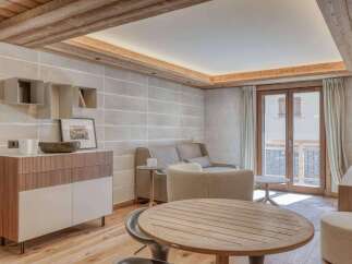Experience luxury living in this stunning property, featuring a beautifully designed living room with wooden accents and a cozy atmosphere.
