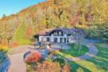 Nestled amidst a vibrant autumnal landscape, this stunning property offers a serene retreat.