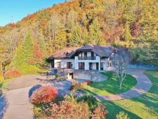 Nestled amidst a vibrant autumnal landscape, this stunning property offers a serene retreat.