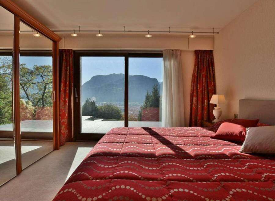 Experience the epitome of luxury in this stunning bedroom with breathtaking mountain views.