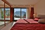 Experience the epitome of luxury in this stunning bedroom with breathtaking mountain views.