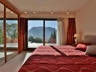 Experience the epitome of luxury in this stunning bedroom with breathtaking mountain views.
