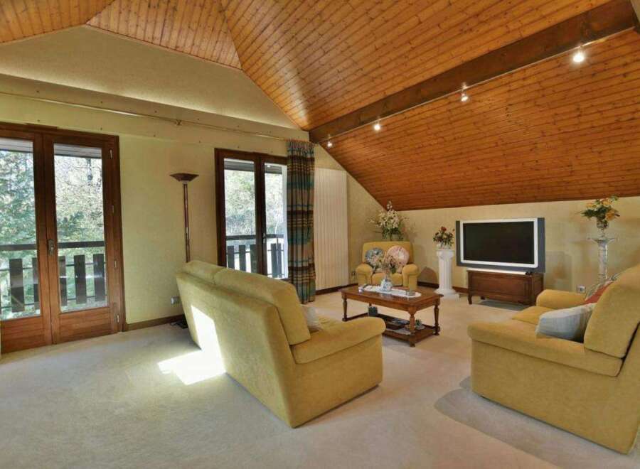 This stunning living room boasts a warm and inviting atmosphere, perfect for relaxation and entertaining.