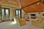 This stunning living room boasts a warm and inviting atmosphere, perfect for relaxation and entertaining.
