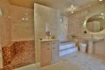 Step into luxury with this stunning bathroom featuring exquisite tile work and a spa-like ambiance.