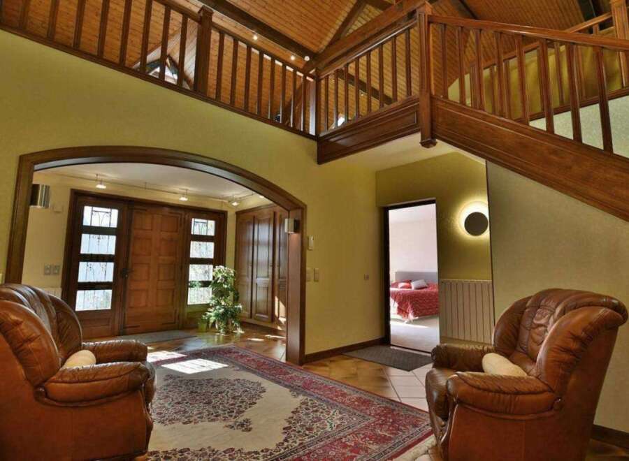Step into luxury with this stunning property featuring a grand entrance and a beautiful wooden staircase.
