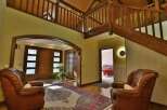 Step into luxury with this stunning property featuring a grand entrance and a beautiful wooden staircase.