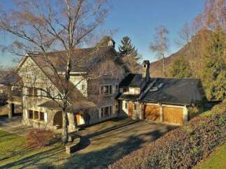This stunning property boasts a beautiful stone facade and a charming architectural design.