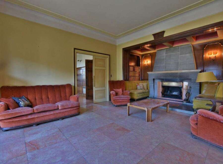 Step into luxury with this stunning living room, featuring a cozy fireplace and elegant design.