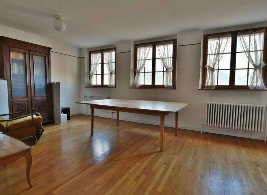 This spacious room features beautiful hardwood floors and ample natural light streaming in from the large windows.