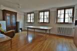 This spacious room features beautiful hardwood floors and ample natural light streaming in from the large windows.
