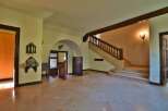 Step into luxury with this stunning property featuring a grand staircase and elegant architectural details.