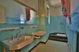 Step back in time with this charming bathroom! Featuring retro turquoise tiles, this space exudes vintage appeal.