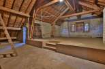 Discover the charm of this unique property, featuring a spacious attic with exposed wooden beams.
