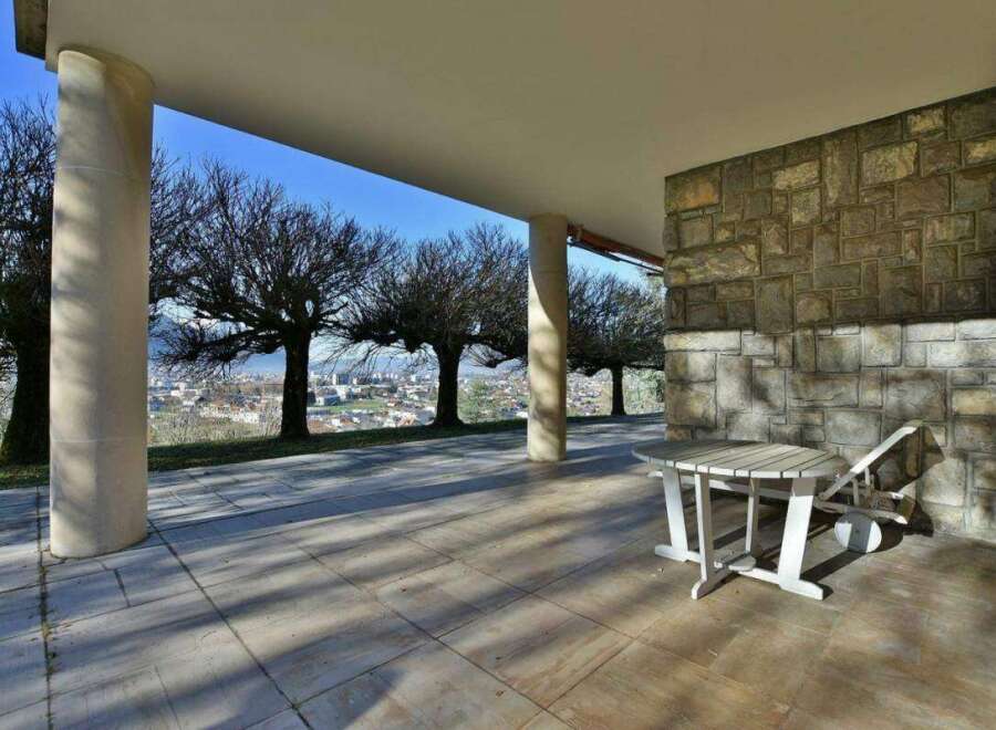 Enjoy breathtaking views from this stunning property! This outdoor space features a charming table and chair set, perfect for relaxing and taking in the scenery.