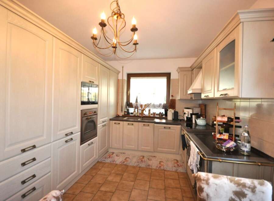 This charming kitchen boasts a classic design with ample storage and modern appliances.