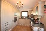This charming kitchen boasts a classic design with ample storage and modern appliances.