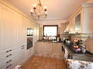 This charming kitchen boasts a classic design with ample storage and modern appliances.