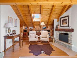 This stunning property boasts a warm and inviting interior with a focus on natural materials.