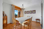 This charming dining room features a rustic wooden table and chairs, perfect for family gatherings.