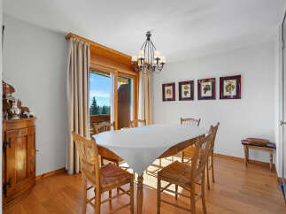 This charming dining room features a rustic wooden table and chairs, perfect for family gatherings.